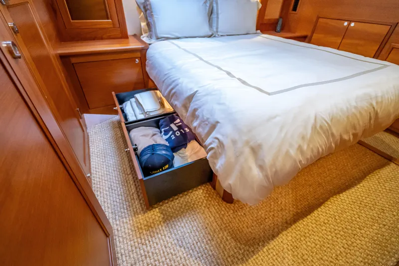 Carole Lyn Yacht Photos Pics Luxurious cabin storage in 2018 Palm Beach Motor Yachts PB55, featuring under-bed drawers.