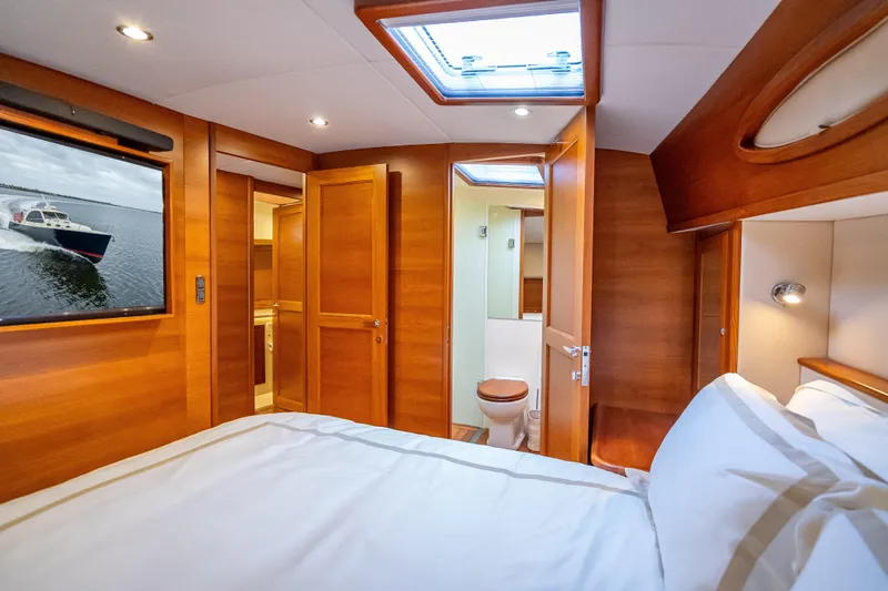 Carole Lyn Yacht Photos Pics Luxurious 2018 Palm Beach Motor Yachts PB55 cabin interior with wood finish and skylight.