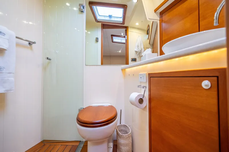 Carole Lyn Yacht Photos Pics Luxurious bathroom in 2018 Palm Beach Motor Yachts PB55, featuring wood accents and modern fixtures.