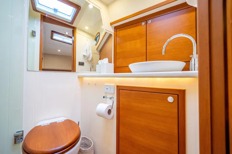 Carole Lyn Yacht Photos Pics Luxurious bathroom in 2018 Palm Beach Motor Yachts PB55, featuring wood accents and modern fixtures.