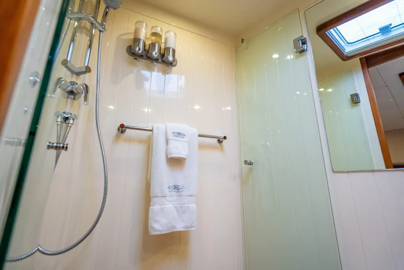 Carole Lyn Yacht Photos Pics Luxurious bathroom in 2018 Palm Beach Motor Yachts PB55, featuring elegant fixtures and plush towels.