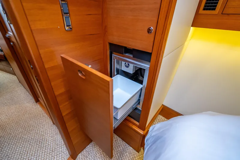 Carole Lyn Yacht Photos Pics 2018 Palm Beach Motor Yachts PB55 interior with open wooden cabinet and drawer.