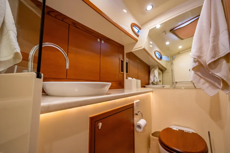 Carole Lyn Yacht Photos Pics Luxurious bathroom interior of 2018 Palm Beach Motor Yachts PB55, featuring elegant wood finishes.