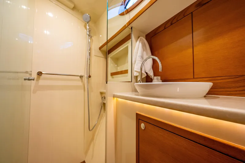 Carole Lyn Yacht Photos Pics Luxurious bathroom interior of 2018 Palm Beach Motor Yachts PB55, featuring elegant wood finishes.