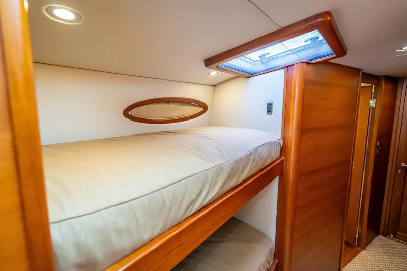Carole Lyn Yacht Photos Pics 2018 Palm Beach Motor Yachts PB55 interior with wooden bunk beds and soft lighting.