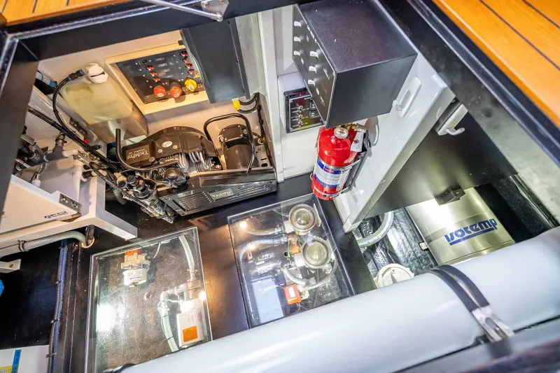 Carole Lyn Yacht Photos Pics Engine room of 2018 Palm Beach Motor Yachts PB55, featuring mechanical components and fire extinguisher.