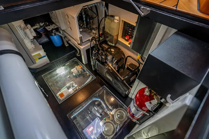 Carole Lyn Yacht Photos Pics Engine room of 2018 Palm Beach Motor Yachts PB55, showcasing equipment and fire extinguisher.