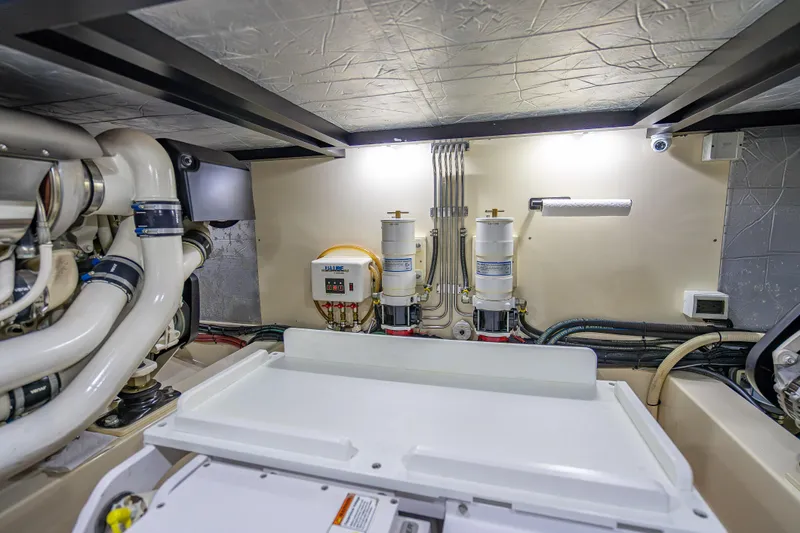 Carole Lyn Yacht Photos Pics Engine room of 2018 Palm Beach Motor Yachts PB55, showcasing mechanical components and systems.