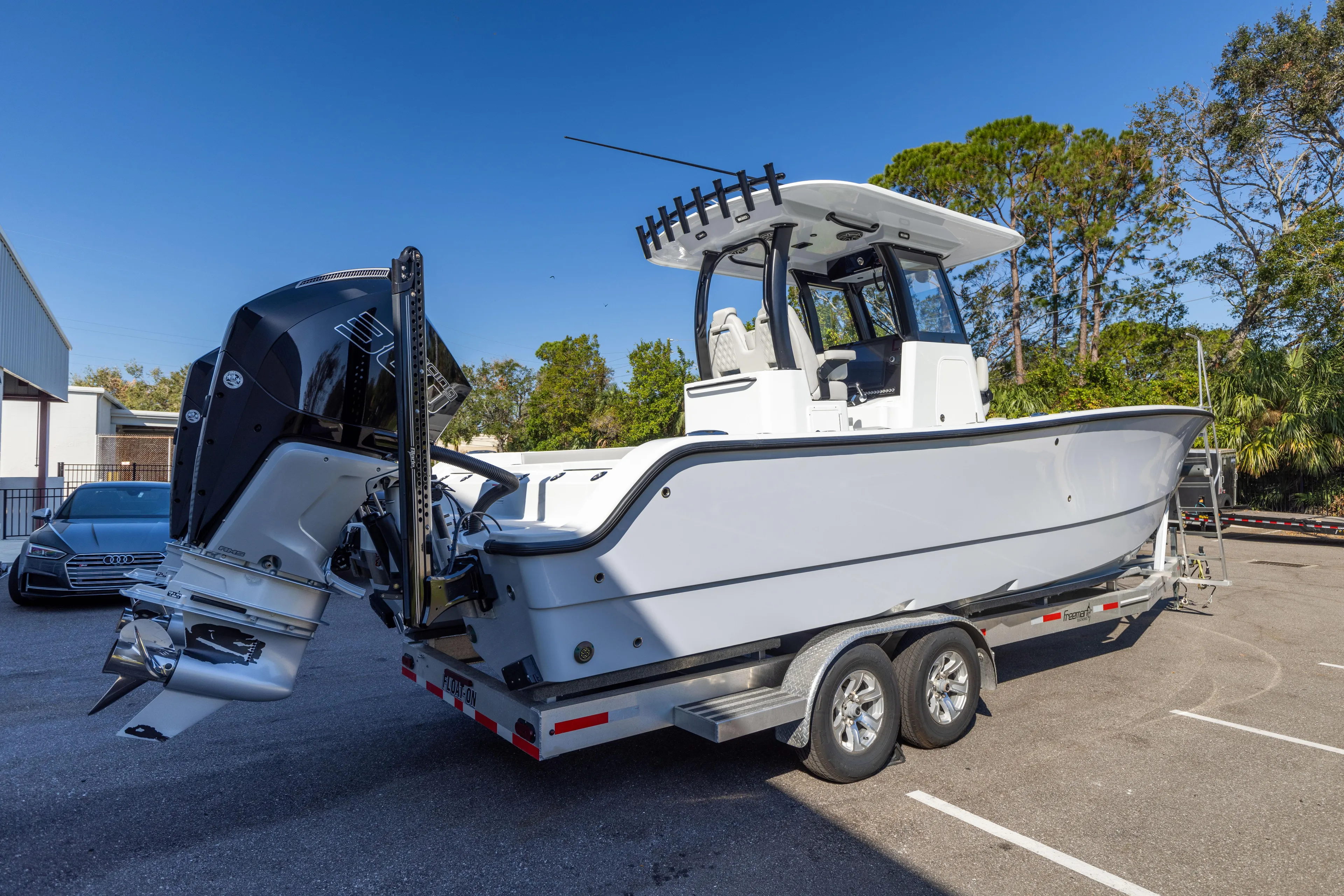  Yacht Photos Pics 2024 Freeman 28 boat on trailer in parking lot, side view.