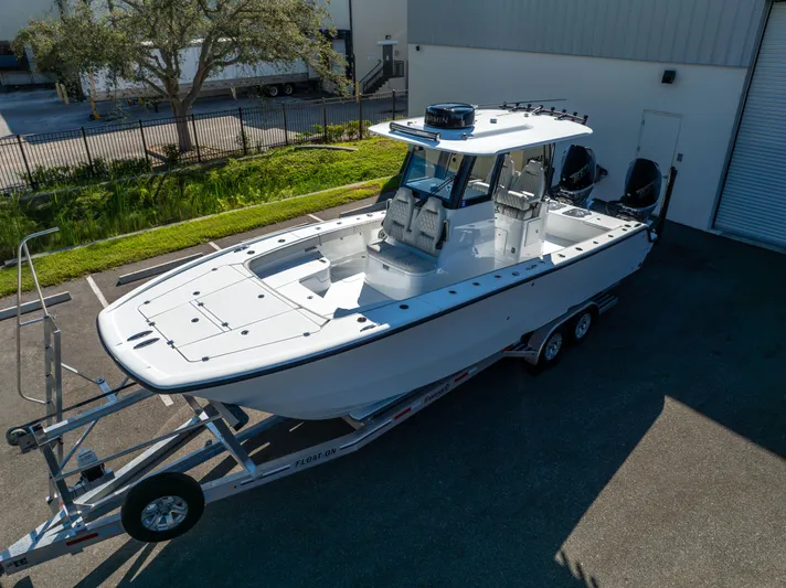  Yacht Photos Pics 2024 Freeman 28 boat on trailer, parked outdoors, ready for transport.