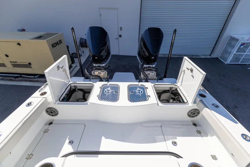  Yacht Photos Pics 2024 Freeman 28 boat with dual engines and open storage compartments.