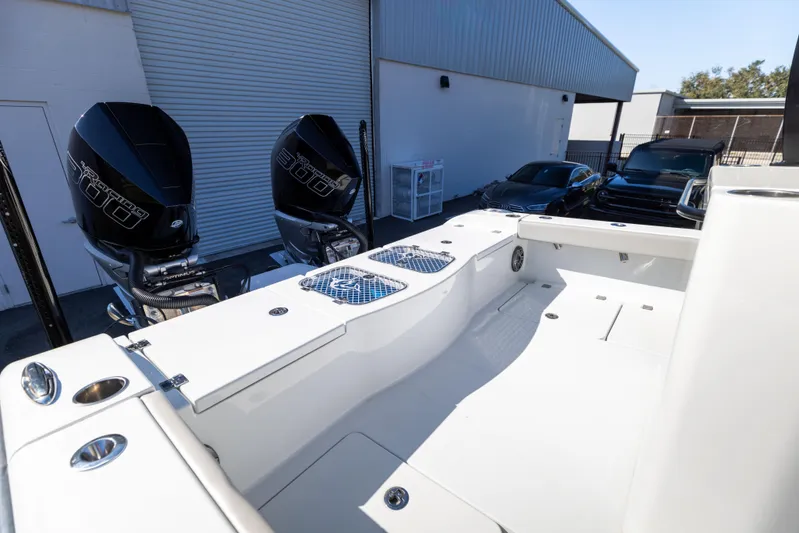  Yacht Photos Pics 2024 Freeman 28 boat with dual outboard motors in a marina setting.