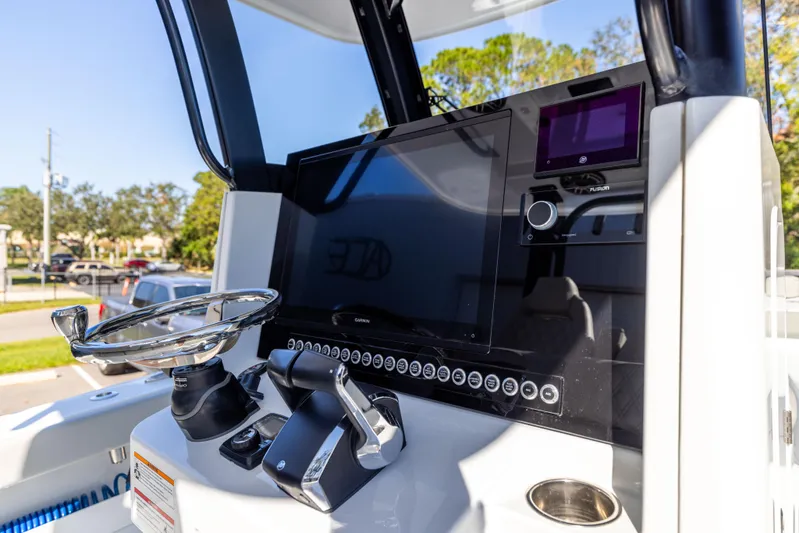  Yacht Photos Pics 2024 Freeman 28 boat dashboard with steering wheel and control panel.