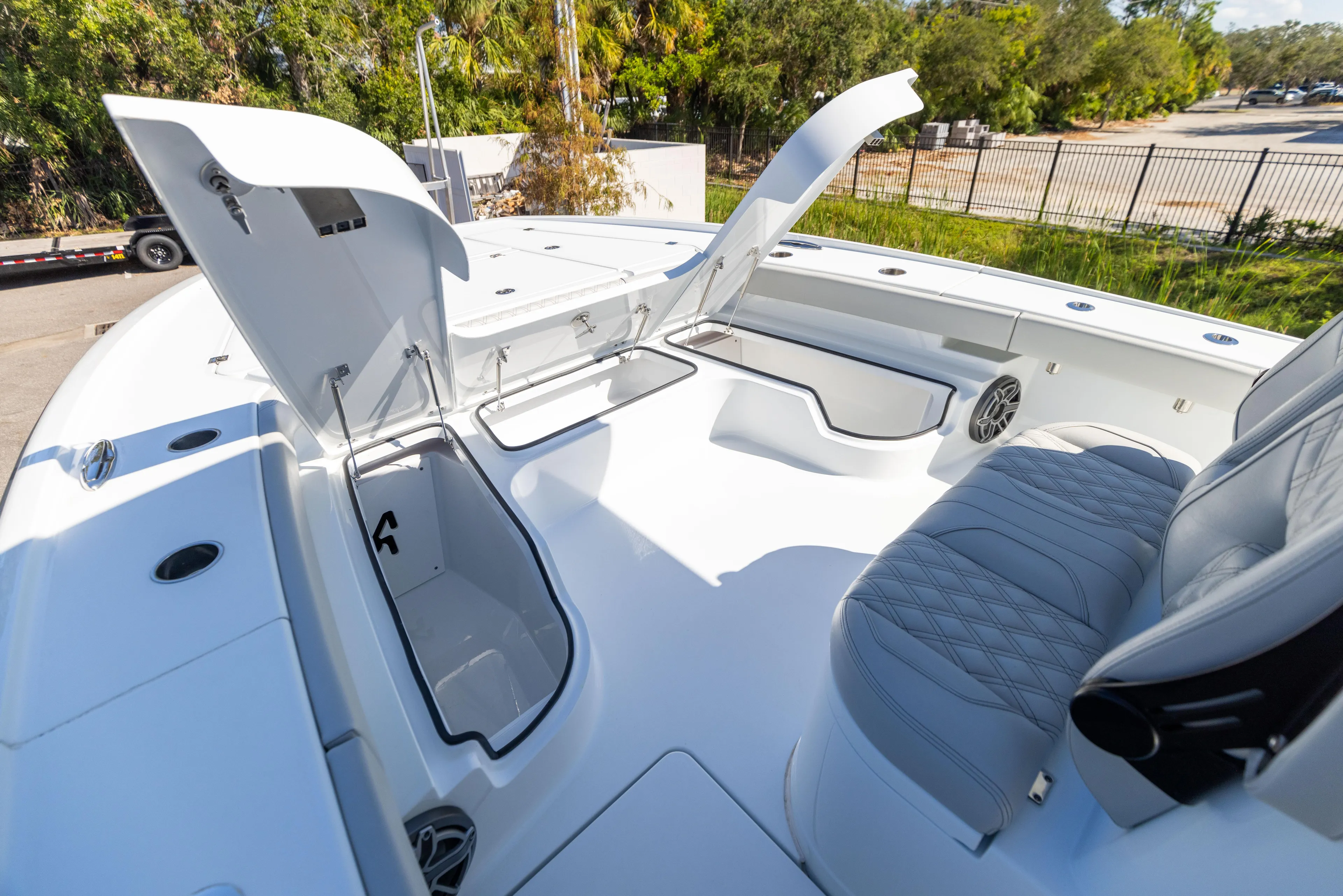  Yacht Photos Pics 2024 Freeman 28 boat with open storage compartments and cushioned seating.