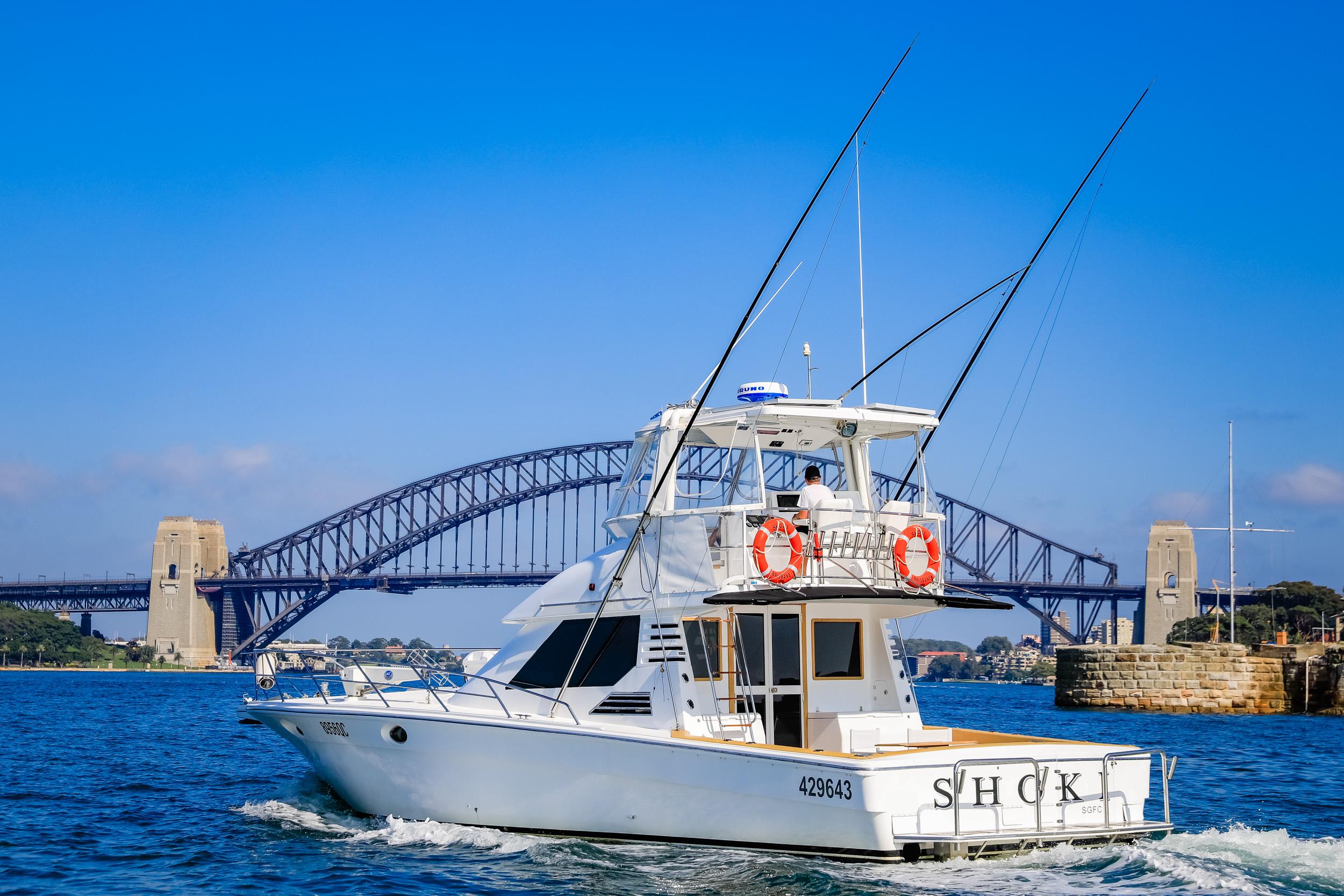 1993 Precision 47 Flybridge boat cruising near iconic bridge on a sunny day.