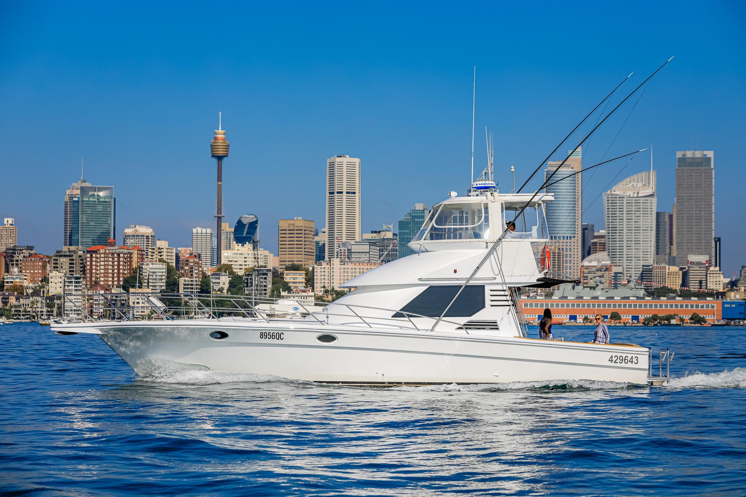 1993 Precision 47 Flybridge yacht cruising near city skyline on a sunny day.