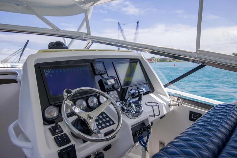 Sunkisser Yacht Photos Pics Intrepid 475 Sport Yacht 2013 helm with advanced navigation and control systems, overlooking blue waters.