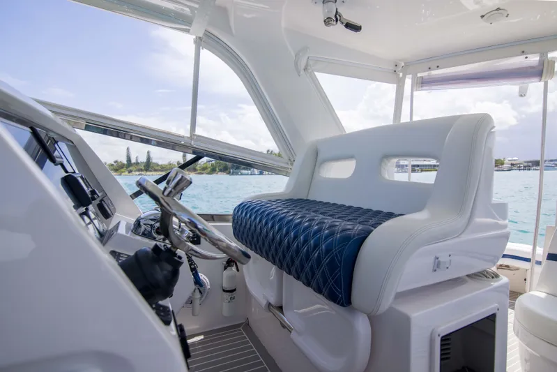 Sunkisser Yacht Photos Pics Interior of 2013 Intrepid 475 Sport Yacht with luxurious seating and steering wheel.
