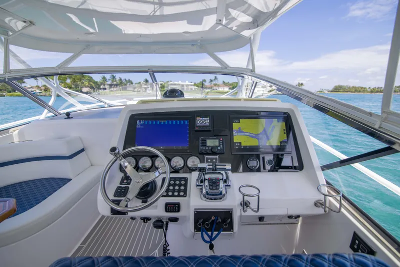 Sunkisser Yacht Photos Pics Helm of 2013 Intrepid 475 Sport Yacht with navigation screens and steering wheel.