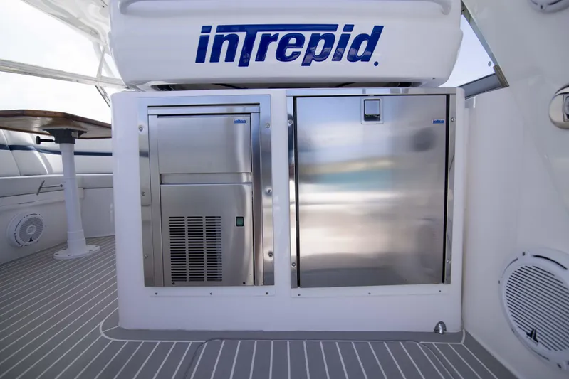 Sunkisser Yacht Photos Pics 2013 Intrepid 475 Sport Yacht interior with stainless steel appliances and seating area.