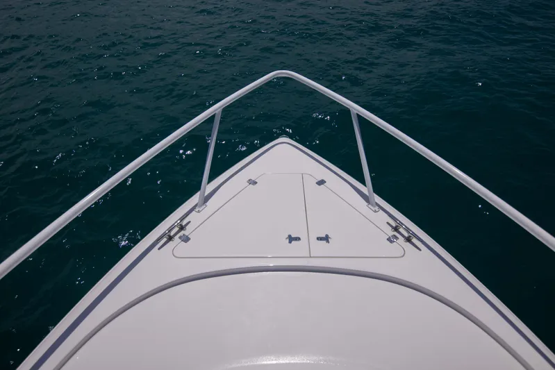 Sunkisser Yacht Photos Pics Bow view of 2013 Intrepid 475 Sport Yacht on calm water.