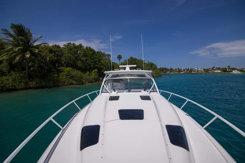 Sunkisser Yacht Photos Pics 2013 Intrepid 475 Sport Yacht cruising in tropical waters under clear blue skies.