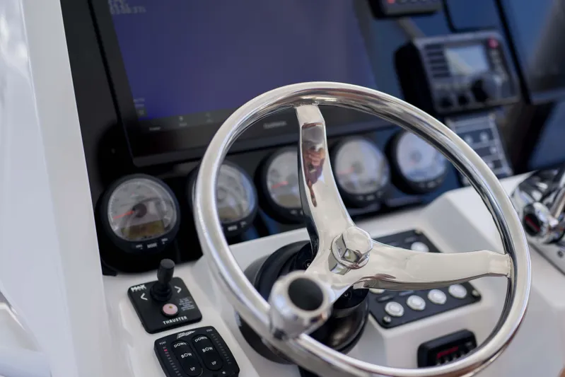 Sunkisser Yacht Photos Pics Steering wheel and dashboard of 2013 Intrepid 475 Sport Yacht, featuring gauges and controls.