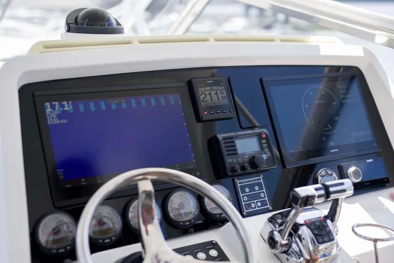 Sunkisser Yacht Photos Pics Control panel of a 2013 Intrepid 475 Sport Yacht with navigation screens and instruments.