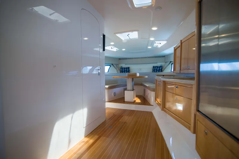 Sunkisser Yacht Photos Pics Luxurious interior of 2013 Intrepid 475 Sport Yacht with wood flooring and modern cabinetry.