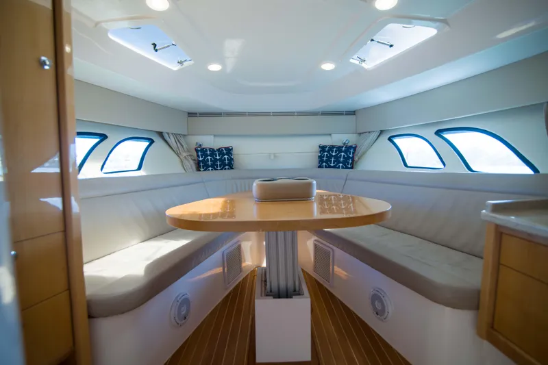 Sunkisser Yacht Photos Pics Luxurious interior of 2013 Intrepid 475 Sport Yacht with elegant seating and table.