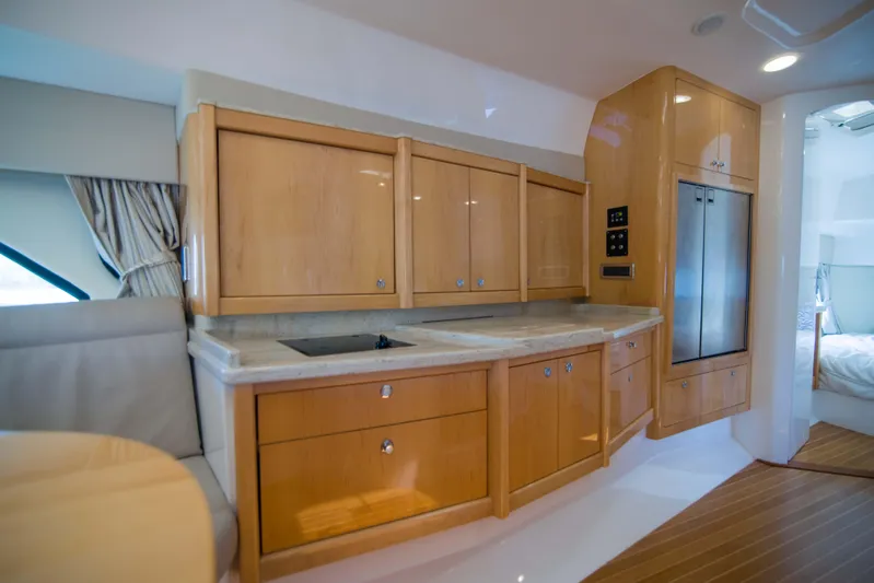 Sunkisser Yacht Photos Pics Luxurious kitchen interior of 2013 Intrepid 475 Sport Yacht with wooden cabinetry and modern appliances.