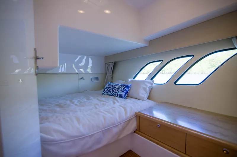 Sunkisser Yacht Photos Pics Luxurious cabin interior of 2013 Intrepid 475 Sport Yacht with cozy bed and scenic windows.