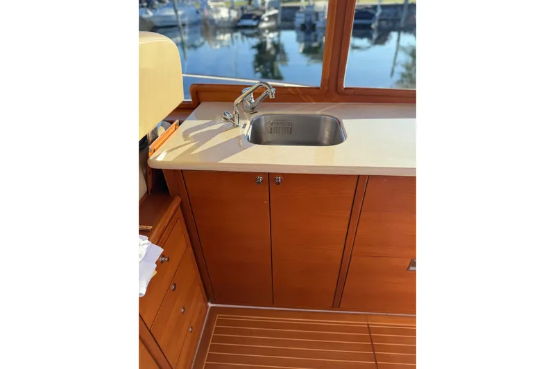  Yacht Photos Pics 2017 Grand Banks 44 Eastbay SX yacht interior with wooden cabinetry and sink.
