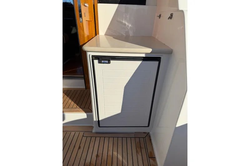  Yacht Photos Pics 2017 Grand Banks 44 Eastbay SX yacht with outdoor cabinet and teak flooring.