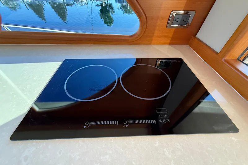  Yacht Photos Pics Modern induction cooktop on 2017 Grand Banks 44 Eastbay SX yacht kitchen counter.