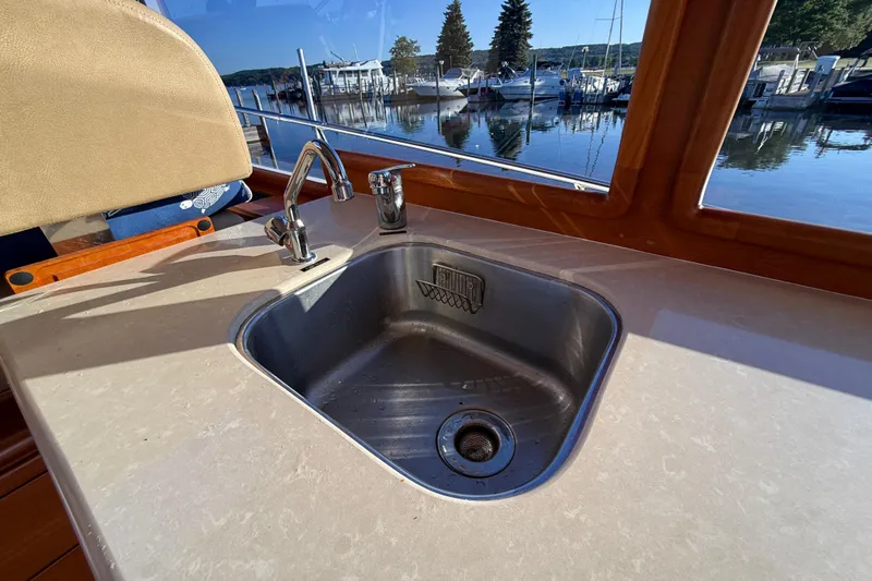  Yacht Photos Pics 2017 Grand Banks 44 Eastbay SX yacht interior with stainless steel sink and marina view.
