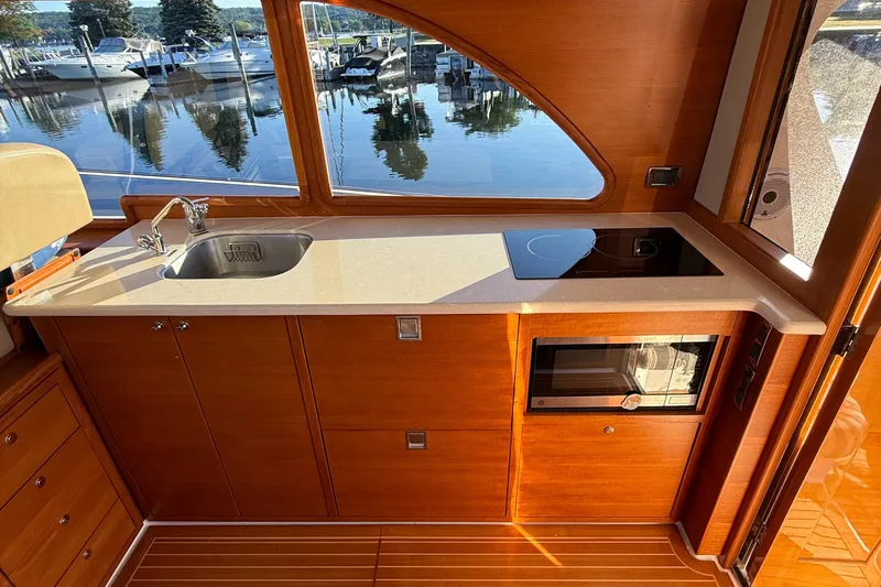  Yacht Photos Pics Luxurious 2017 Grand Banks 44 Eastbay SX yacht kitchen with sink, stove, and microwave.