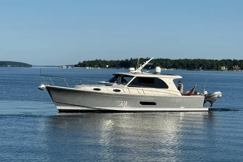  Yacht Photos Pics 2017 Grand Banks 44 Eastbay SX yacht cruising on a serene lake.