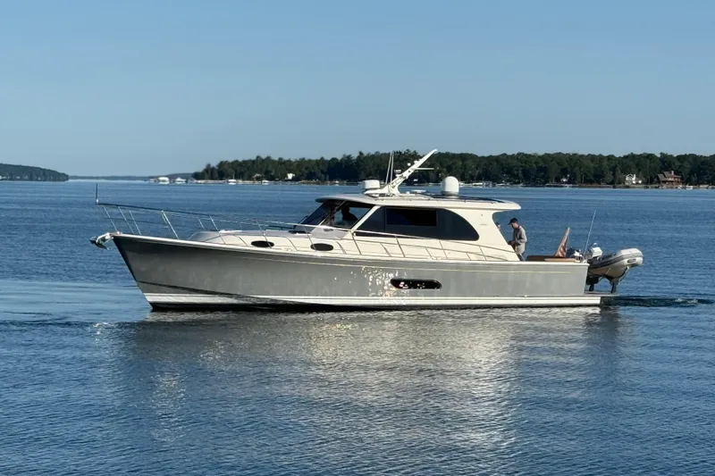  Yacht Photos Pics 2017 Grand Banks 44 Eastbay SX yacht cruising on calm waters.