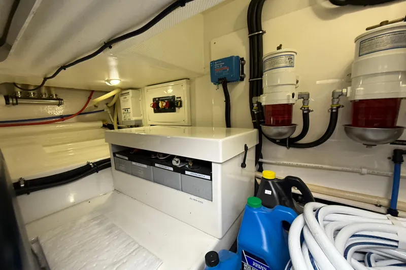  Yacht Photos Pics Engine room of 2017 Grand Banks 44 Eastbay SX with fuel filters and maintenance supplies.