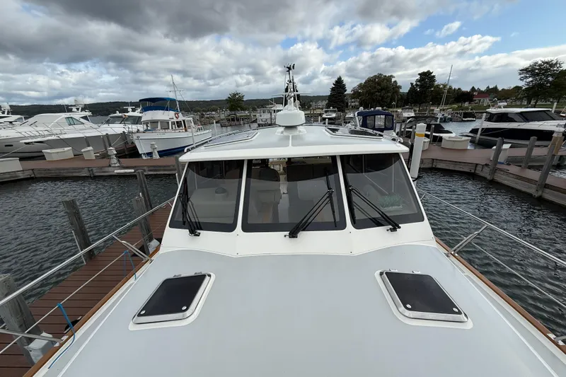  Yacht Photos Pics 2017 Grand Banks 44 Eastbay SX docked at a marina under cloudy skies.