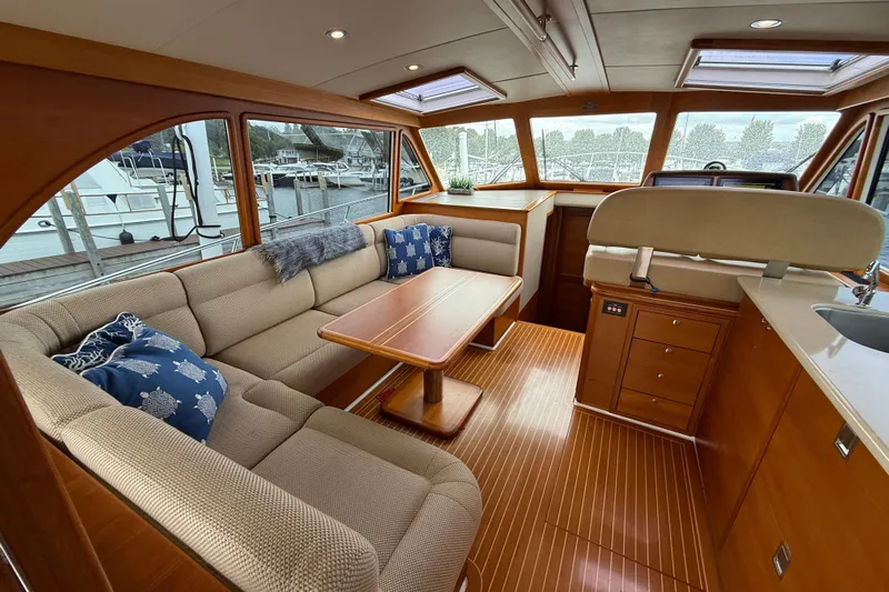  Yacht Photos Pics Luxurious interior of 2017 Grand Banks 44 Eastbay SX yacht with elegant seating and wooden finishes.