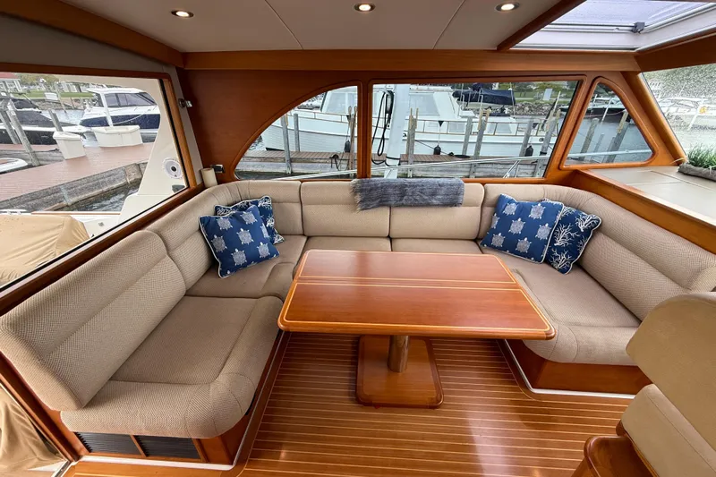  Yacht Photos Pics Luxurious 2017 Grand Banks 44 Eastbay SX yacht interior with elegant seating and wooden table.