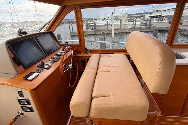  Yacht Photos Pics Helm station of 2017 Grand Banks 44 Eastbay SX with dual screens and beige seating.