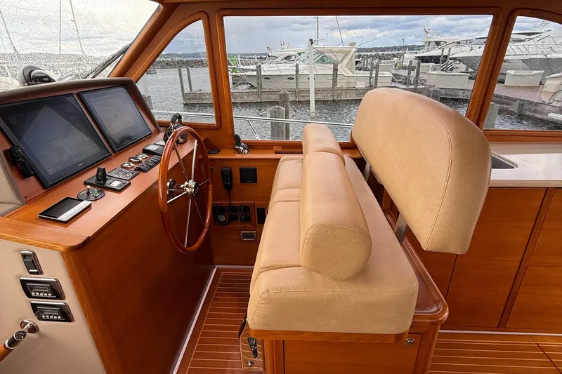  Yacht Photos Pics 2017 Grand Banks 44 Eastbay SX helm with wooden steering wheel and navigation screens.