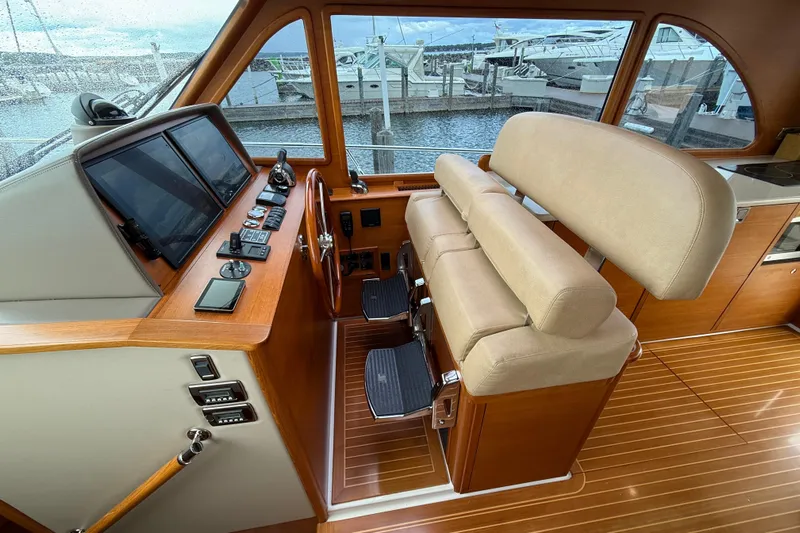  Yacht Photos Pics 2017 Grand Banks 44 Eastbay SX helm with leather seating and wooden dashboard.