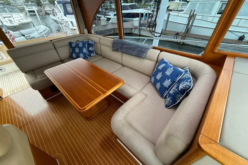  Yacht Photos Pics Luxurious 2017 Grand Banks 44 Eastbay SX yacht interior with elegant seating and wooden table.