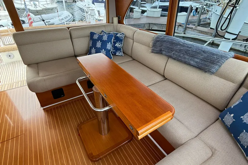  Yacht Photos Pics Luxurious interior of 2017 Grand Banks 44 Eastbay SX yacht with plush seating and wooden table.