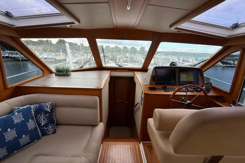  Yacht Photos Pics Luxurious interior of 2017 Grand Banks 44 Eastbay SX yacht with helm and seating area.