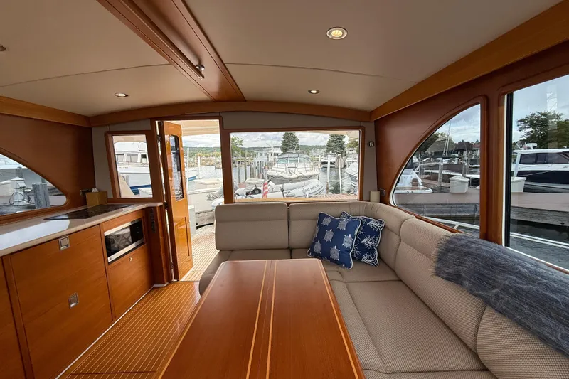  Yacht Photos Pics Luxurious interior of 2017 Grand Banks 44 Eastbay SX yacht with elegant wood finish.